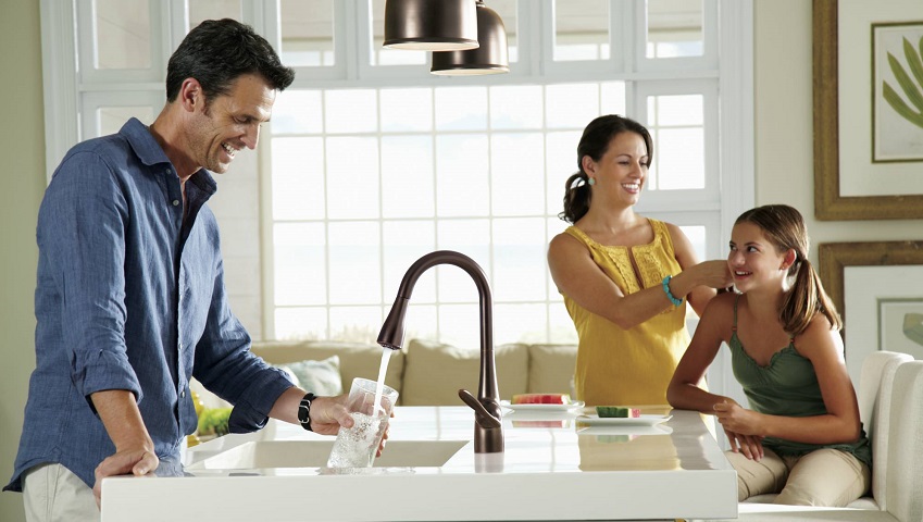 Family in kitchen at sink